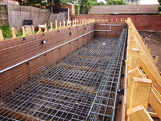 Reinforced concrete pool base